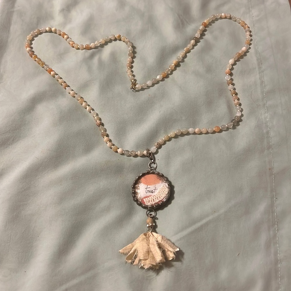 Beaded necklace with trust pendant